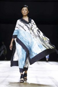 fashion model on a runway wearing blue and white.